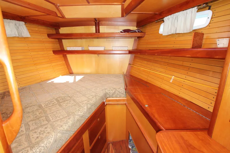 Slide: The Image of Cozy wooden interior of 1998 Able Apogee 50 sailboat cabin with bed and shelves. - 17