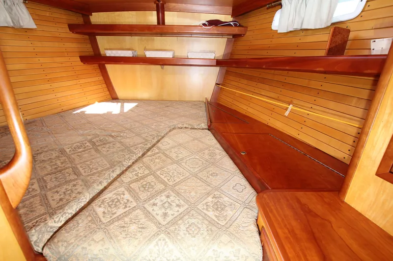 Slide: The Image of Cozy wooden cabin interior of 1998 Able Apogee 50 sailboat with patterned bedding. - 18