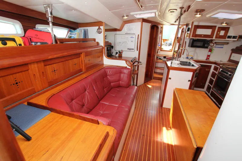 Slide: The Image of Interior of 1998 Able Apogee 50 yacht with red leather seating and wooden finishes. - 20