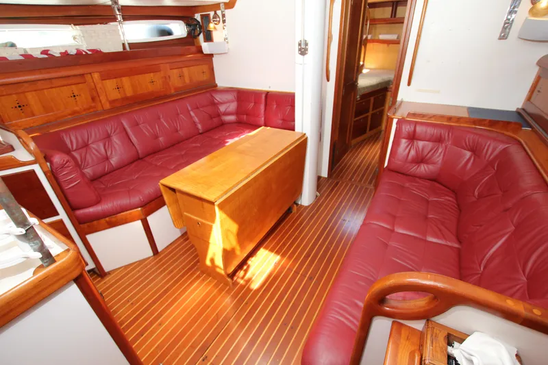 Slide: The Image of Luxurious interior of 1998 Able Apogee 50 yacht with red leather seating and wooden accents. - 22