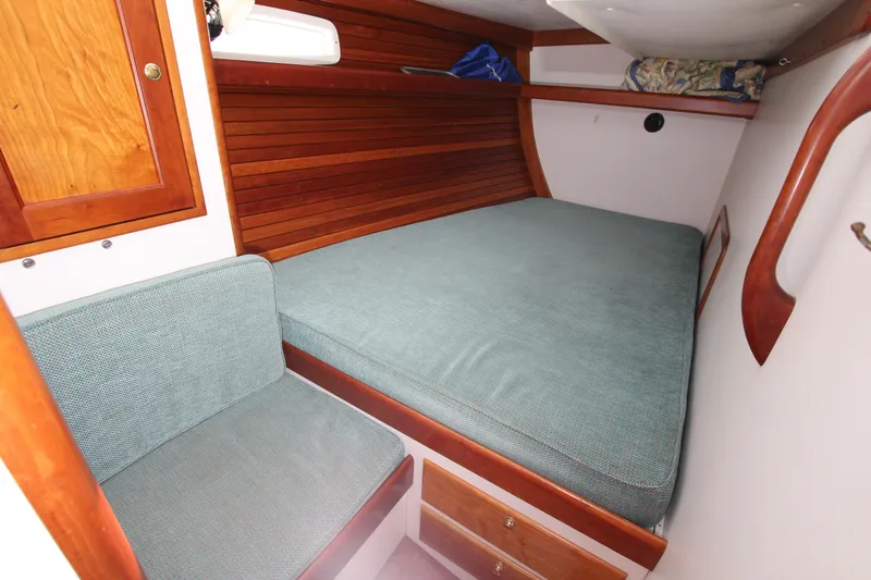 Slide: The Image of Cozy cabin interior of 1998 Able Apogee 50 sailboat with wooden accents and cushioned seating. - 26