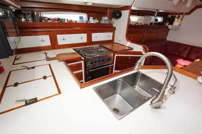 Slide: The Image of Spacious kitchen in 1998 Able Apogee 50 yacht with stove, sink, and wooden cabinetry. - 27