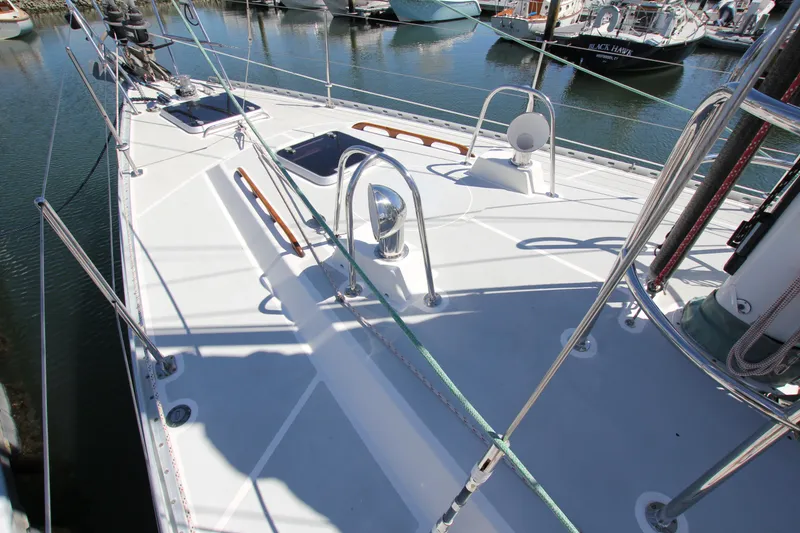 Slide: The Image of Deck of 1998 Able Apogee 50 sailboat in marina, showcasing sleek design and rigging. - 3