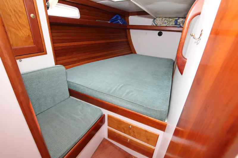 Slide: The Image of Cozy cabin interior of 1998 Able Apogee 50 sailboat with wooden accents and teal upholstery. - 31
