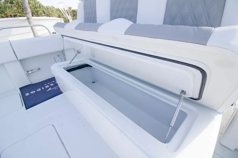 Slide: The Image of 2026 Invincible 39 Open Fisherman boat with open storage compartment and cushioned seating. - 17
