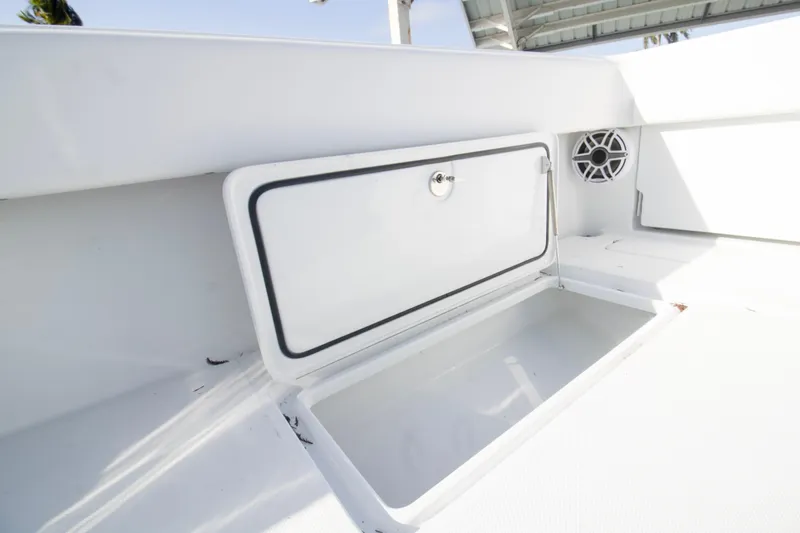 Slide: The Image of 2026 Invincible 39 Open Fisherman boat storage compartment with speaker detail. - 18