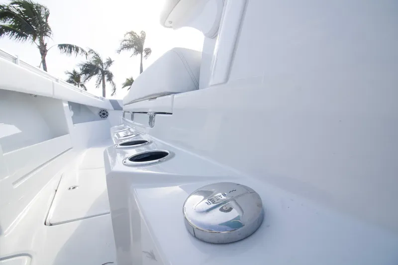 Slide: The Image of 2026 Invincible 39 Open Fisherman boat deck with palm trees in background. - 23