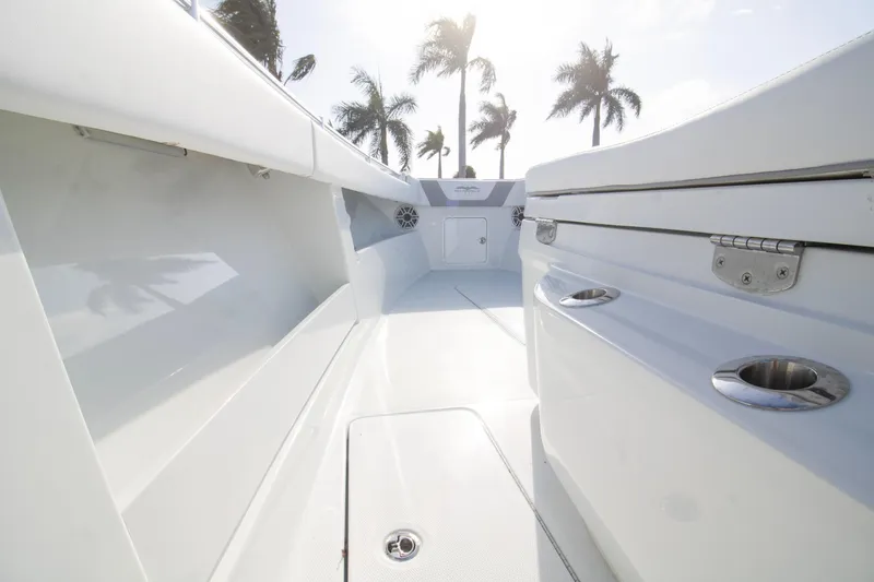 Slide: The Image of 2026 Invincible 39 Open Fisherman boat interior with sleek design and palm trees in background. - 24