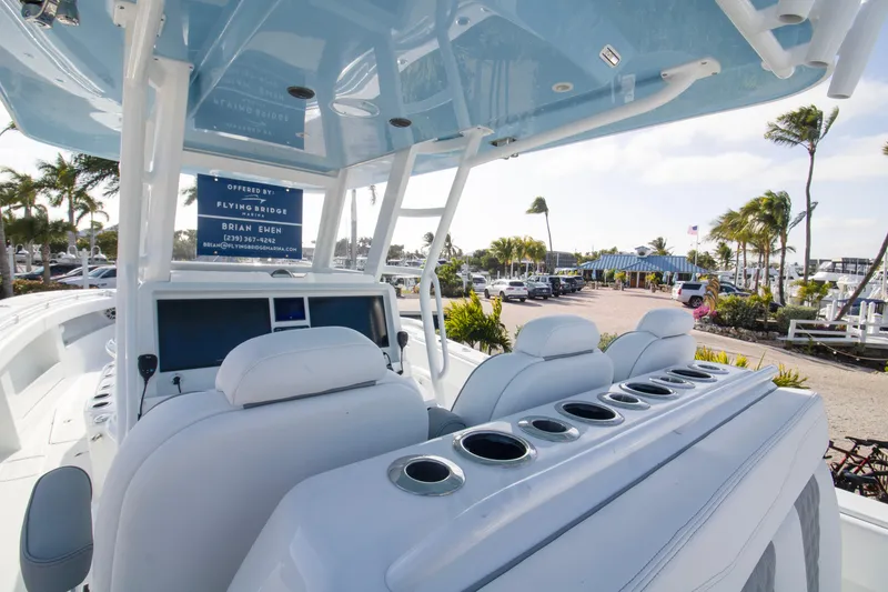 Slide: The Image of 2026 Invincible 39 Open Fisherman boat interior with helm and seating, dockside view. - 4