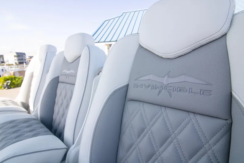 Slide: The Image of Luxury seating on 2026 Invincible 39 Open Fisherman boat, featuring elegant stitching and branding. - 5