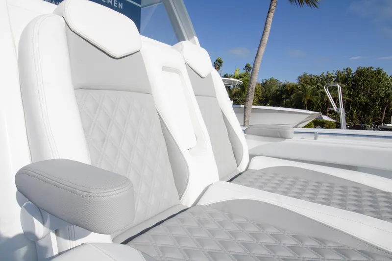 Slide: The Image of Luxurious seating on 2026 Invincible 39 Open Fisherman boat, featuring elegant white and gray upholstery. - 9
