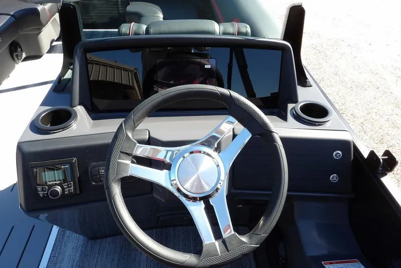 Slide: The Image of 2026 Bennington S Swingback 22 SSB boat dashboard with steering wheel and controls. - 18