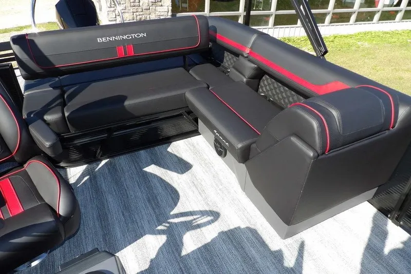 Slide: The Image of 2026 Bennington S Swingback 22 SSB boat interior with black and red seating. - 25