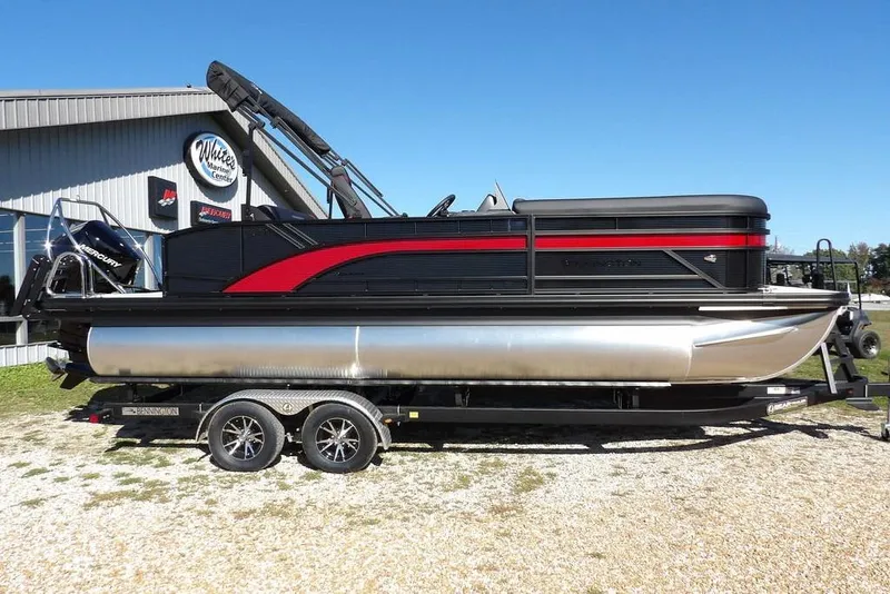 Slide: The Image of 2026 Bennington S Swingback 22 SSB pontoon boat on trailer, displayed outdoors. - 4