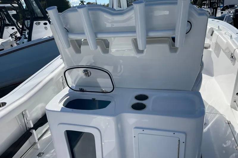 Slide: The Image of 2026 Tidewater 272 CC Adventure boat interior with rod holders and storage compartments. - 18
