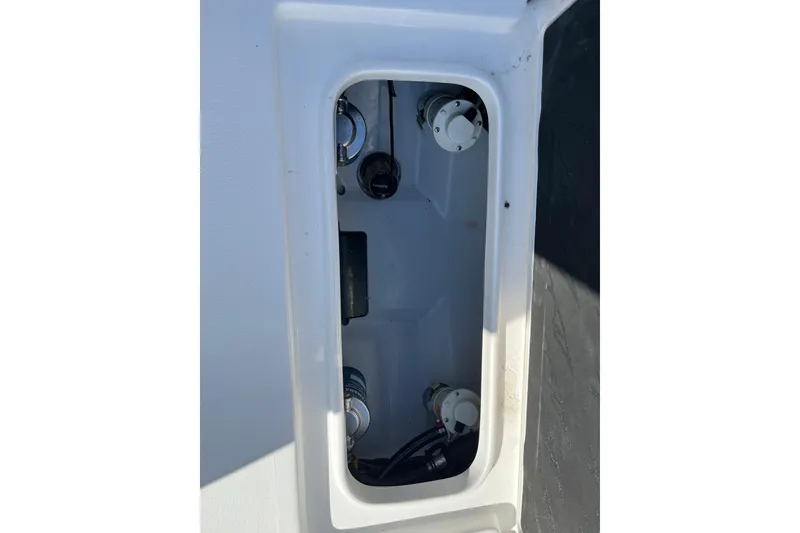 Slide: The Image of 2026 Tidewater 272 CC Adventure boat compartment with visible fittings and components. - 22