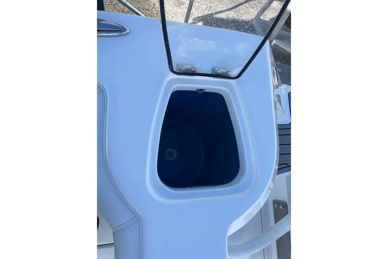 Slide: The Image of Open storage compartment on 2026 Tidewater 272 CC Adventure boat. - 26