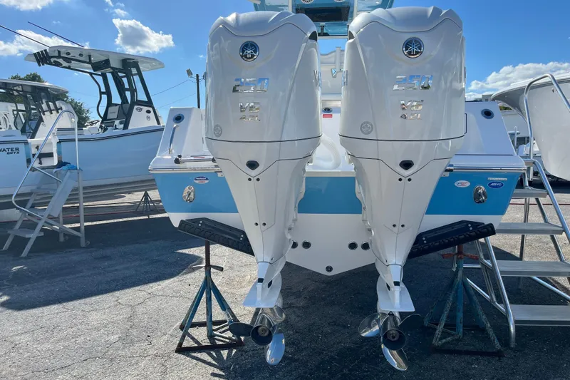 Slide: The Image of 2026 Tidewater 272 CC Adventure boat with dual outboard engines displayed outdoors. - 5