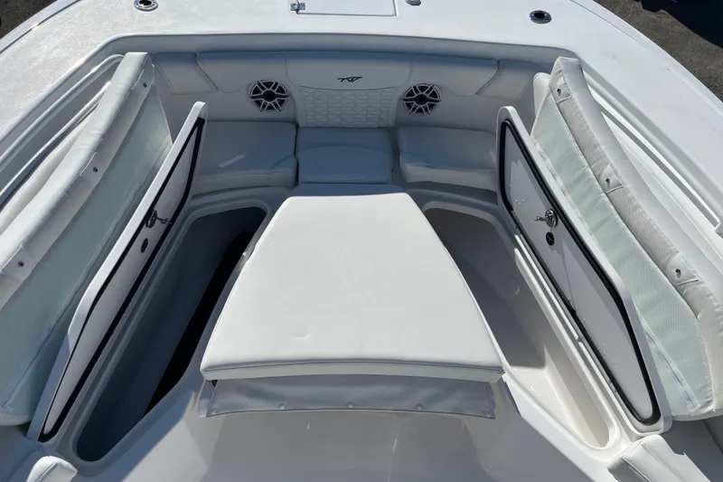 Slide: The Image of 2026 Tidewater 272 CC Adventure boat interior with cushioned seating and storage compartments. - 8