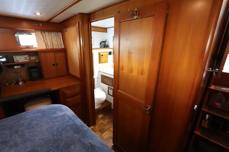 Slide: The Image of Interior of 2005 DeFever 49 Cockpit Motor Yacht with wooden cabinetry and cozy furnishings. - 102