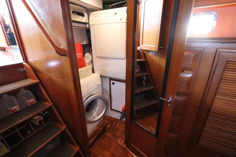 Slide: The Image of Laundry area inside 2005 DeFever 49 Cockpit Motor Yacht with wooden interior. - 107