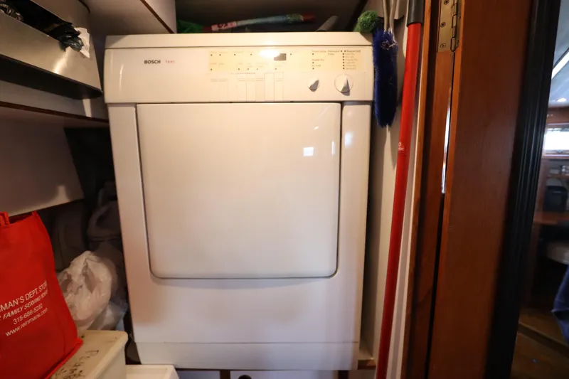 Slide: The Image of Bosch dryer inside 2005 DeFever 49 Cockpit Motor Yacht laundry area. - 109