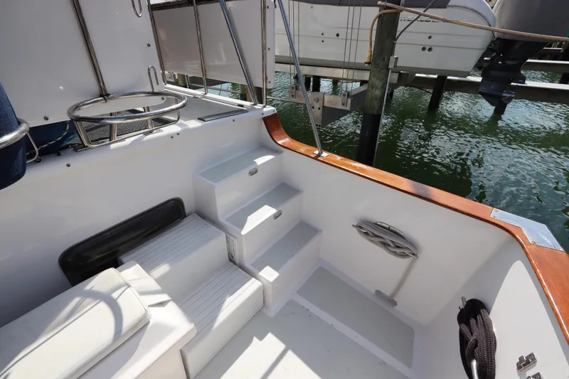 Slide: The Image of 2005 DeFever 49 Cockpit Motor Yacht interior with steps and railing by the water. - 13