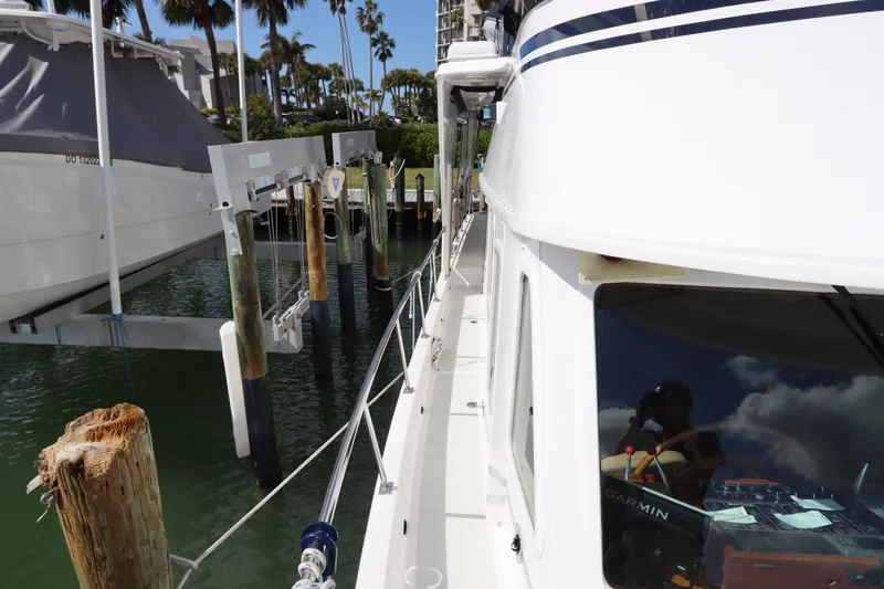 Slide: The Image of 2005 DeFever 49 Cockpit Motor Yacht docked at marina with clear skies. - 21