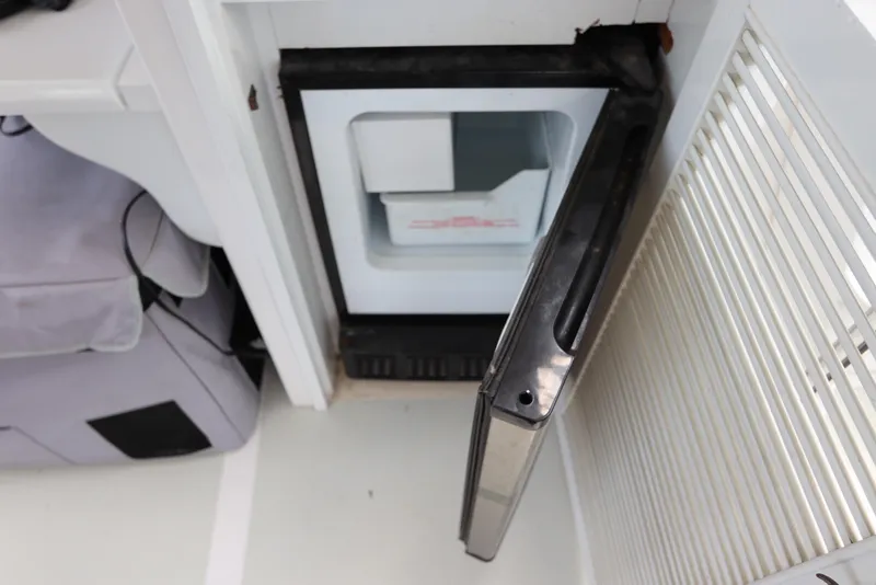 Slide: The Image of Open mini fridge on 2005 DeFever 49 Cockpit Motor Yacht, interior view. - 26