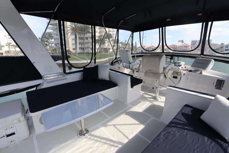 Slide: The Image of Luxurious interior of 2005 DeFever 49 Cockpit Motor Yacht with seating and navigation area. - 30