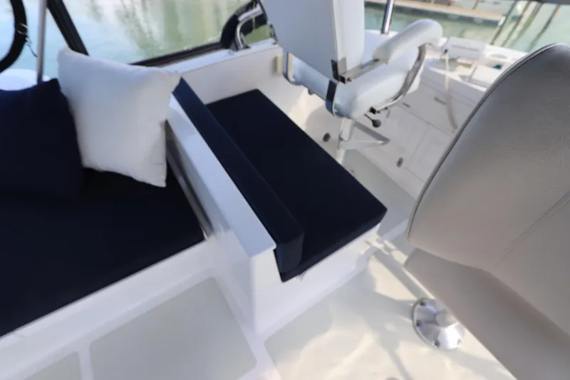 Slide: The Image of 2005 DeFever 49 Cockpit Motor Yacht interior with seating and helm chair. - 33