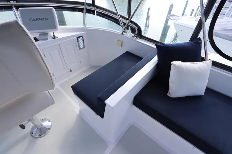 Slide: The Image of 2005 DeFever 49 Cockpit Motor Yacht interior with seating and Garmin navigation system. - 34