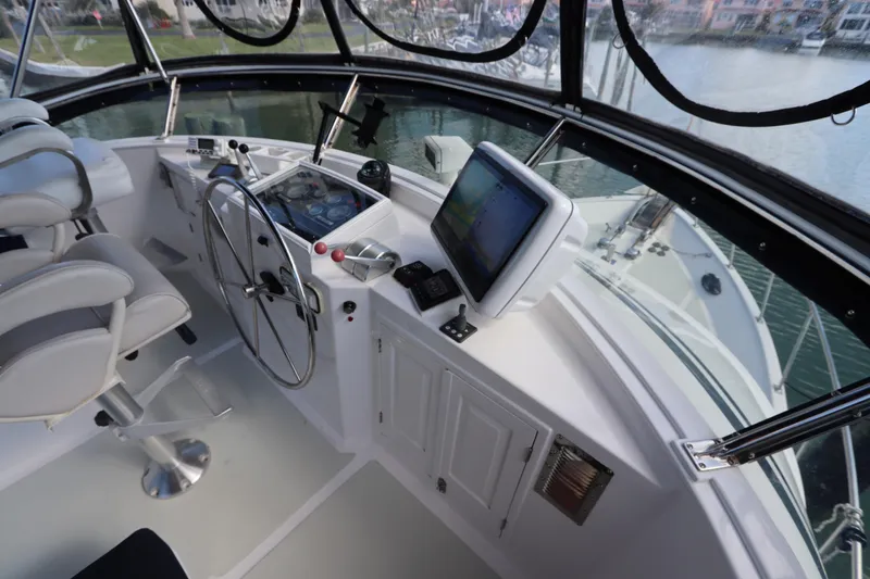 Slide: The Image of Cockpit view of 2005 DeFever 49 Cockpit Motor Yacht with steering wheel and navigation equipment. - 36