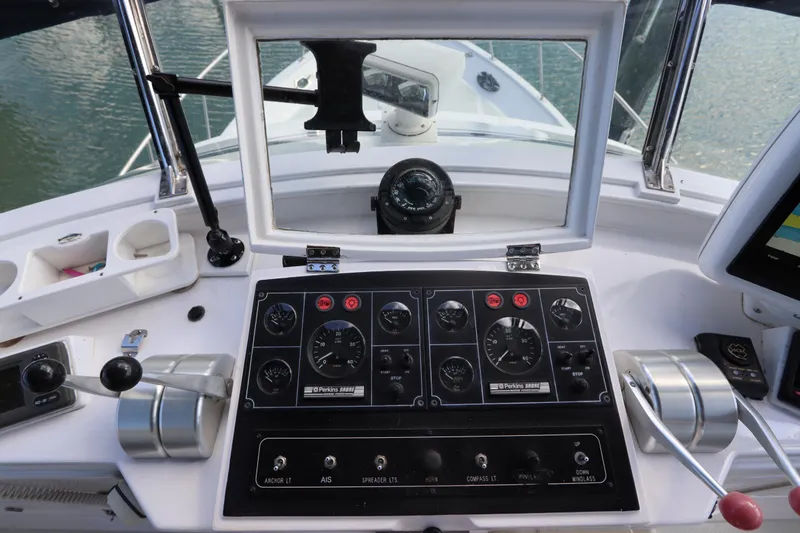 Slide: The Image of Control panel of a 2005 DeFever 49 Cockpit Motor Yacht with navigational instruments. - 38