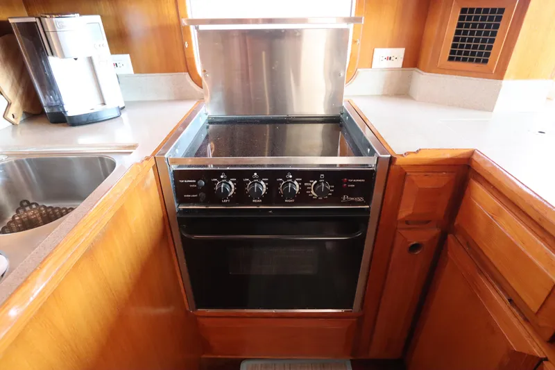 Slide: The Image of Galley kitchen in 2005 DeFever 49 Cockpit Motor Yacht with stove and sink. - 51