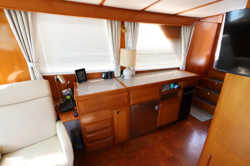 Slide: The Image of Interior of 2005 DeFever 49 Cockpit Motor Yacht with wooden cabinetry and seating area. - 55