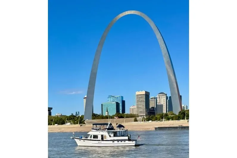 Slide: The Image of 2005 DeFever 49 Cockpit Motor Yacht cruising near iconic city arch and skyline. - 7