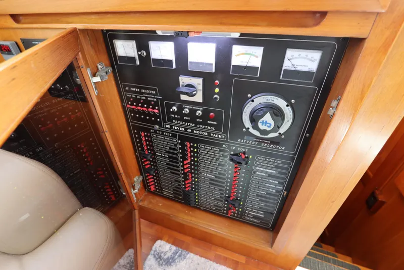 Slide: The Image of Electrical control panel of 2005 DeFever 49 Cockpit Motor Yacht, featuring gauges and switches. - 72