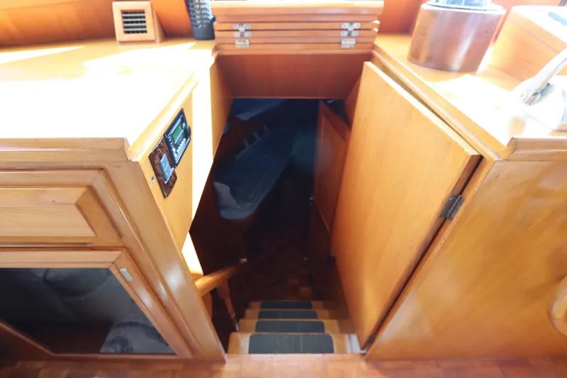 Slide: The Image of Interior view of 2005 DeFever 49 Cockpit Motor Yacht, featuring wooden cabinetry and stairs. - 75