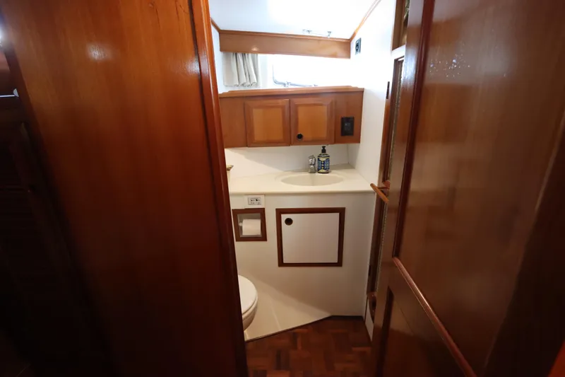 Slide: The Image of Bathroom interior of 2005 DeFever 49 Cockpit Motor Yacht with wooden cabinetry. - 77