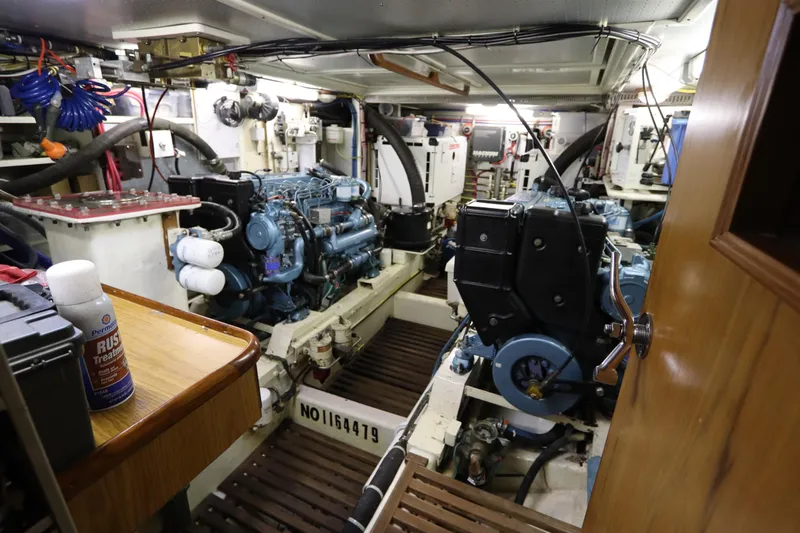 Slide: The Image of Engine room of 2005 DeFever 49 Cockpit Motor Yacht, showcasing dual engines and equipment. - 85
