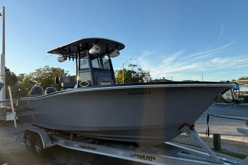 The Image of 2023 NauticStar 2602 Legacy boat on trailer under clear sky. - 0