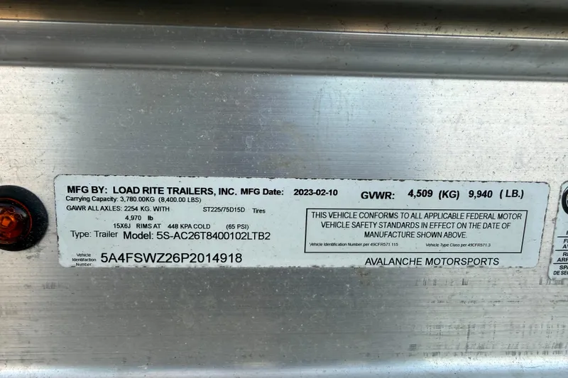 Slide: The Image of 2023 NauticStar 2602 Legacy trailer label, Load Rite Trailers, GVWR 9,940 lbs, Avalanche Motorsports. - 10