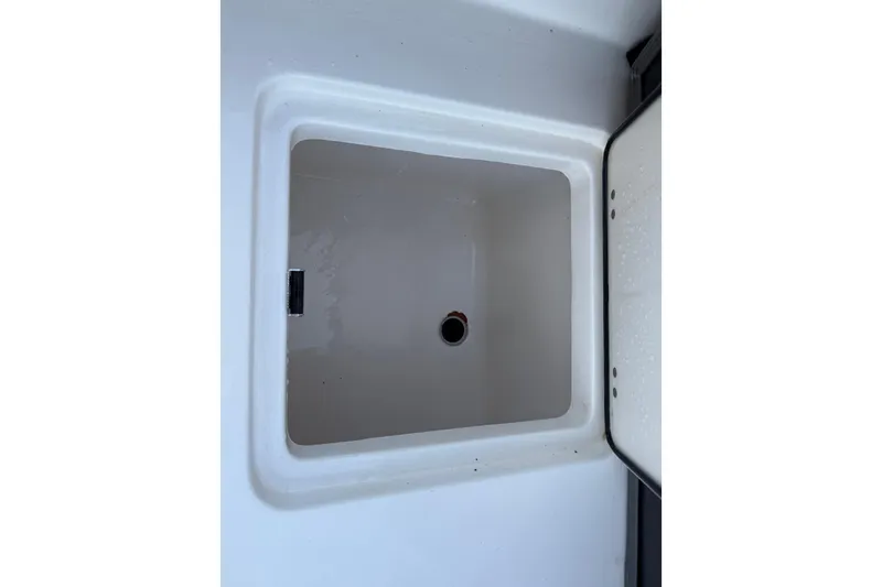 Slide: The Image of 2023 NauticStar 2602 Legacy boat storage compartment, open and empty. - 15