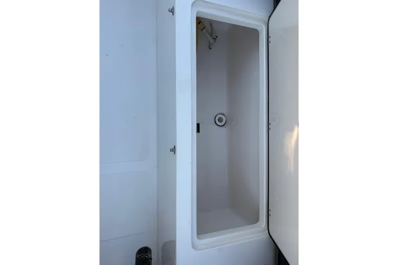 Slide: The Image of 2023 NauticStar 2602 Legacy boat storage compartment, open and empty. - 17