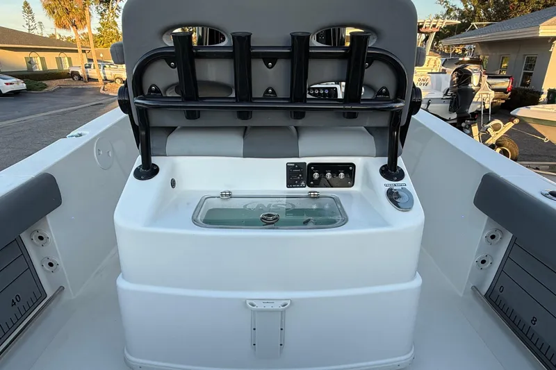Slide: The Image of 2023 NauticStar 2602 Legacy boat interior with rod holders and control panel. - 22