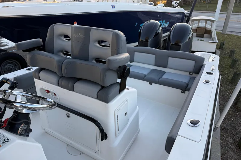 Slide: The Image of 2023 NauticStar 2602 Legacy boat interior with dual seating and steering wheel. - 28