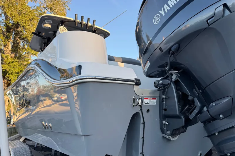 Slide: The Image of 2023 NauticStar 2602 Legacy boat with Yamaha engine, sleek design, outdoor setting. - 3