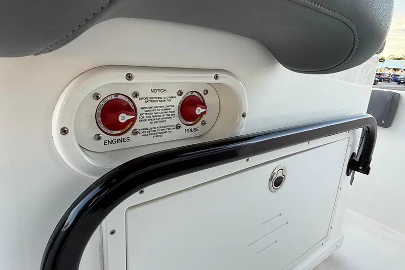 Slide: The Image of Battery control panel on 2023 NauticStar 2602 Legacy boat, featuring engine and house switches. - 32