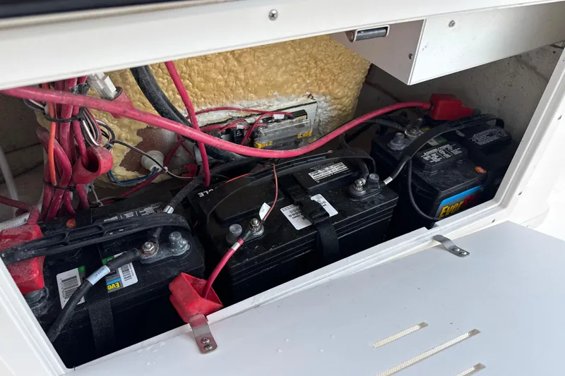Slide: The Image of Battery compartment of 2023 NauticStar 2602 Legacy boat with wiring and connections. - 33
